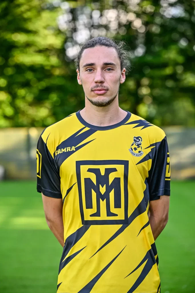 The captain from the first team in his kit, posing on the pitch